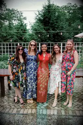 Bride wearing Chinese wedding attire with guests in Western clothing