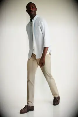 Model wearing khaki chinos with button-down shirt