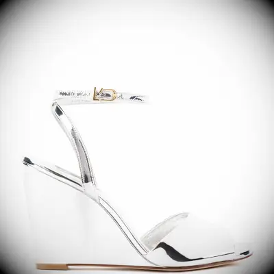 Shiny silver ankle-strap wedges from Larroudé