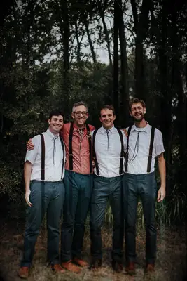 Groom and groomsmen wearing matching bolo ties on wedding day