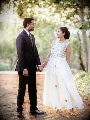 Bride wearing white floral Indian reception dress
