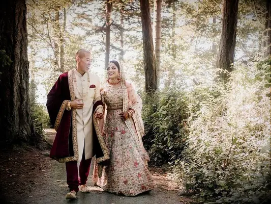 Bride wearing gold bridal lehenga with red embellishemnts