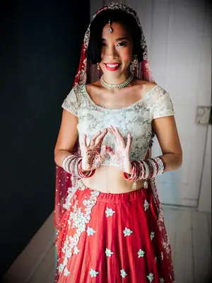 Bride wearing red and gold lehenga choli