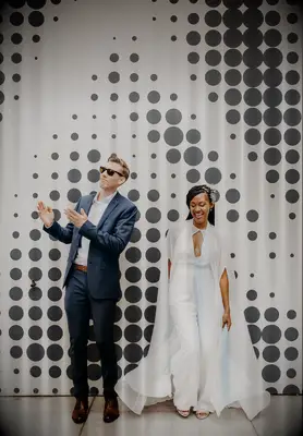 Plunge-neck nontraditional wedding jumpsuit with cape