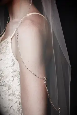 Close up shot of a sheer veil with beaded trim. 
