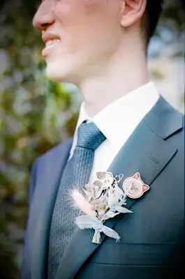 Man wearing animal brooch boutonnieres