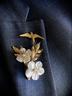 Gold lapel pin with florals and birds