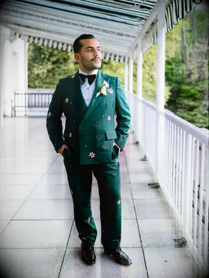 Man wearing a green suit with gold star details