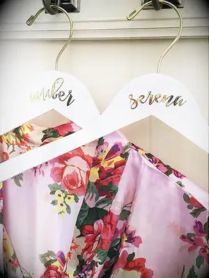 White hanger with name in gold foil script