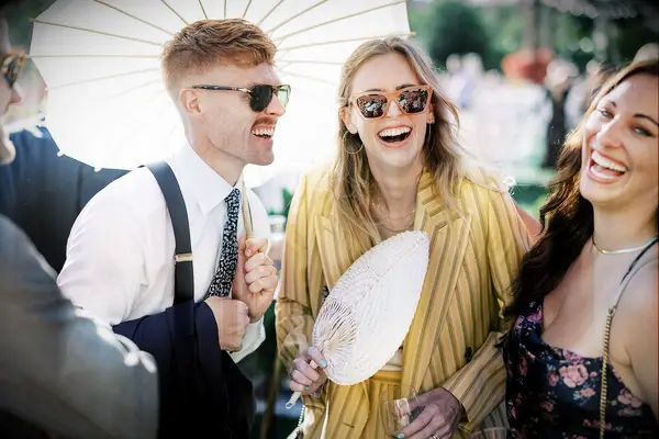 Guests laughing at an outdoor wedding reception