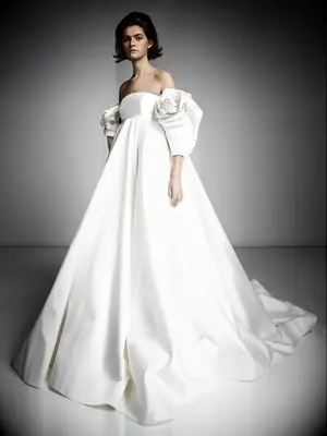 Dramatic off-the-shoulder empire wedding gown with rose sleeves