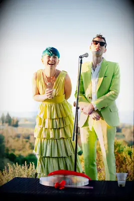 A groom and bride in lime green wedding attire