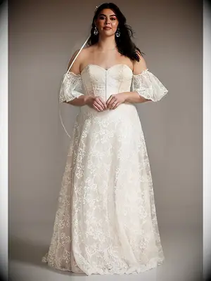 Plus size lace wedding dress with corset bodice and removable puff sleeves