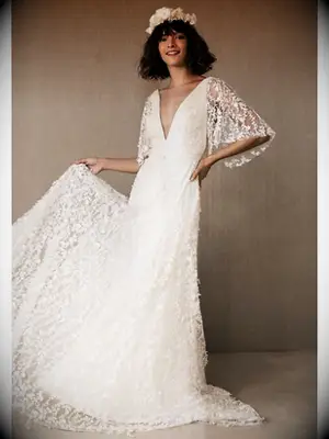 Lace A-line wedding dress with plunging neckline and sheer lace flutter sleeves