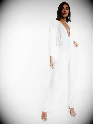 Sequin ivory jumpsuit with plunging neckline and bell sleeves and pant legs