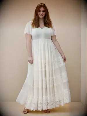 A-line plus-size wedding dress with Swiss dot flutter sleeves and tiered lace skirt