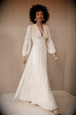 Nude wedding dress with white embroidery, plunging V-neckline and billow cuff sleeves