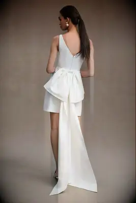 Mini Sachin & Babi wedding dress with a bow in the back. 