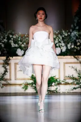 Short wedding dress with a bow at the waist. 