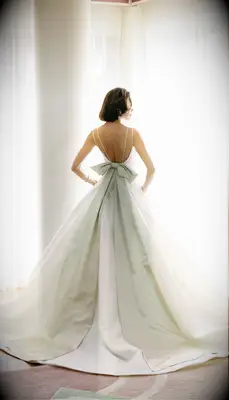 Wedding dress with oversized green bow by Mark Ingram Bride. 