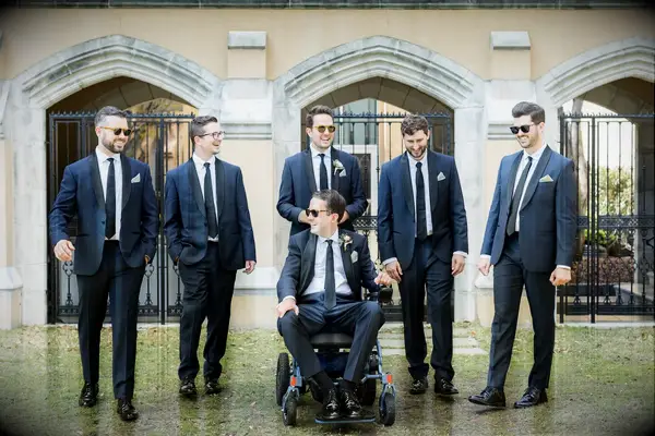 Groom with groomsmen in matching navy suits