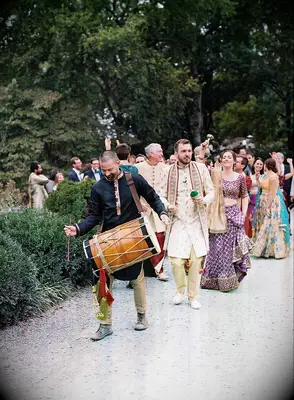 Musician guiding guests to ceremony