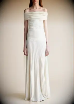 Off-the-shoulder drop waist dress with a pleated skirt. 