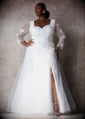 Plus size wedding dress with leg slit and mesh sleeves