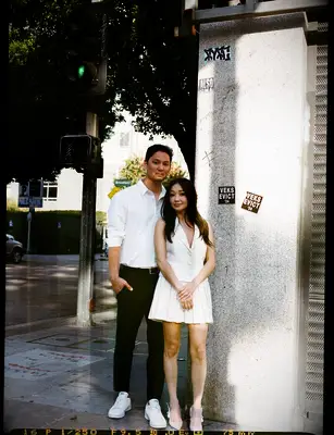 Couple posing for a picture on a street