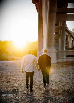 Couple holding hands during golden hour