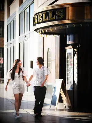 Couple walking hand in hand past a theater
