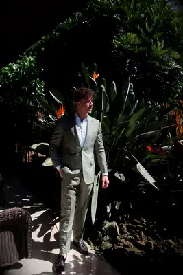 Man wearing gray suit jacket and white button down shirt