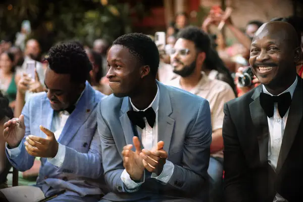 Close up shot of wedding guests wearing suits