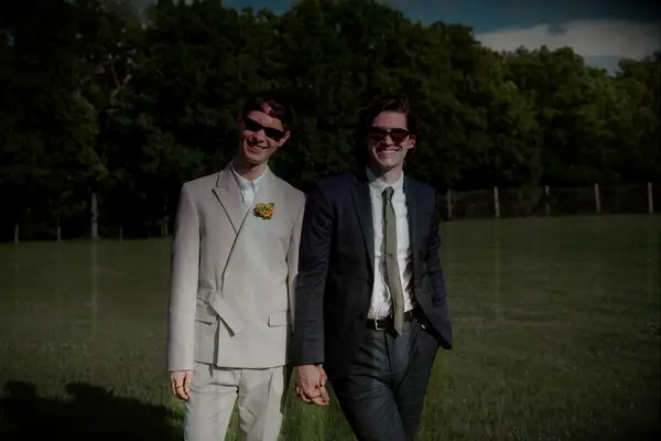 Guests smiling in their suits