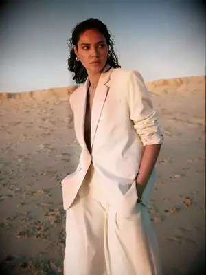 Woman wearing oversized ivory two piece lesbian wedding suit