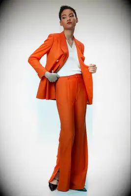 Woman wearing bright orange two piece lesbian wedding suit 