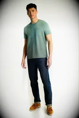Man wearing a green shirt and jeans