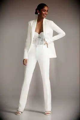 Woman wearing a white suit with mesh strapless top