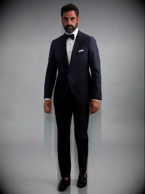 Man wearing a dark navy suit with bow tie