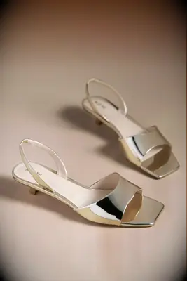 Anthropologie gold heels to wear with brown dress