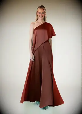 One-shoulder cascading rust-colored jumpsuit for grandmother of the bride