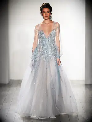 Dusty blue ethereal wedding gown by Hayley Paige with long sleeves and plunging neckline