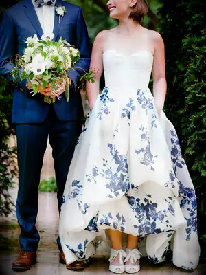 ​White wedding gown by Francesca Miranda​​ with blue flower designs