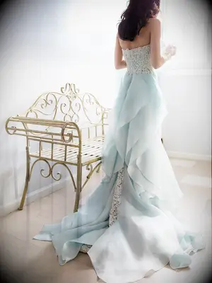 Light blue Oscar de la Renta wedding gown with a lace column silhouette and organza ruffle train