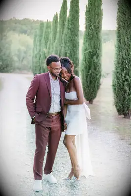 couple poses on tree-lined path