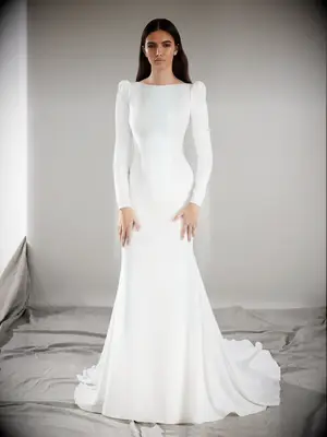 Body-hugging long sleeved wedding dress with structured shoulders
