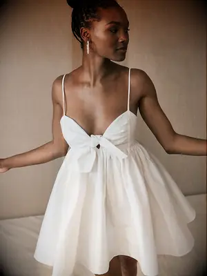 Mini dress with spaghetti straps and bow