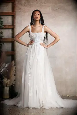 Bride wearing an off-white, square neck flowy a-line wedding gown made out of georgette fabric