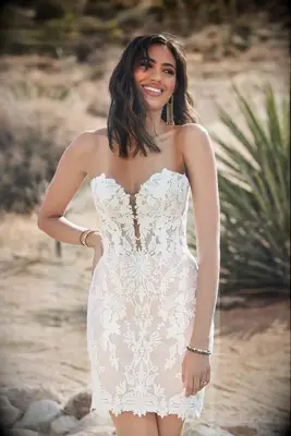 Bride wearing short, strapless wedding dress made out of point d