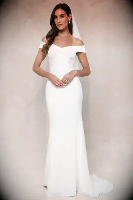 Bride wearing a white, off the shoulder polyester wedding dress